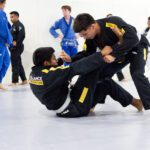 Two grapplers working a guard pass during live jiu-jitsu sparring