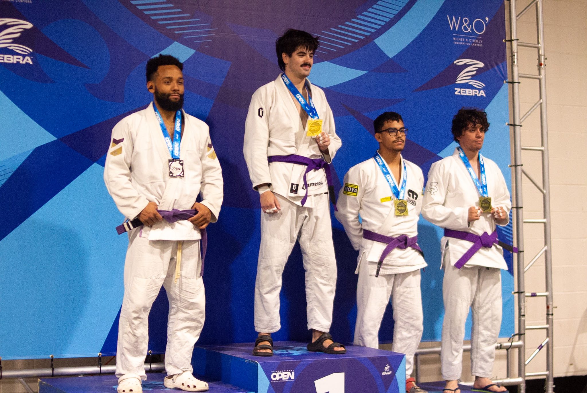 Adult purple belt competitors on the podium at the IBJJF Houston Open championship