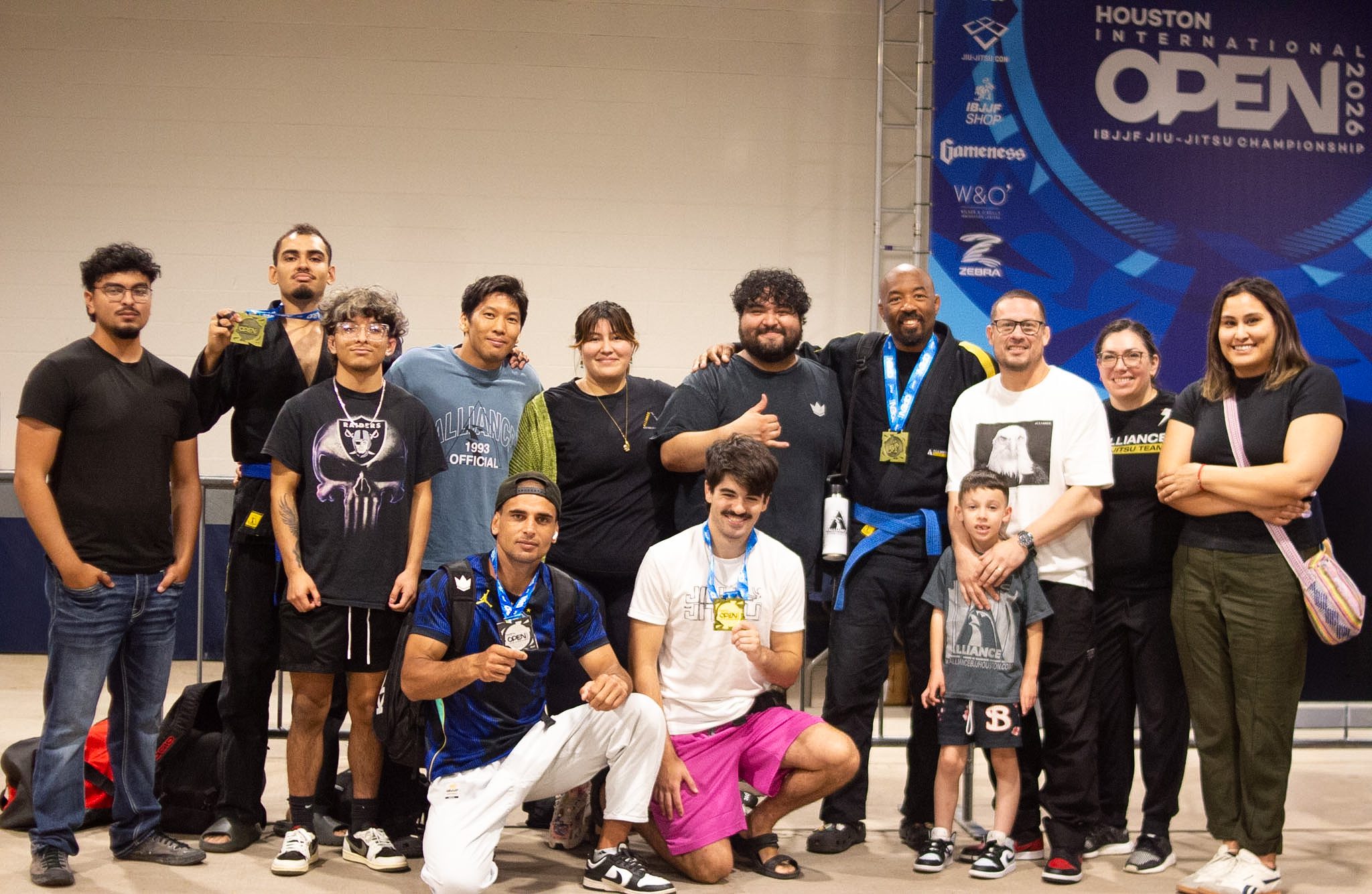 Alliance BJJ team and supporters posing with medals after the IBJJF Houston Open 2026
