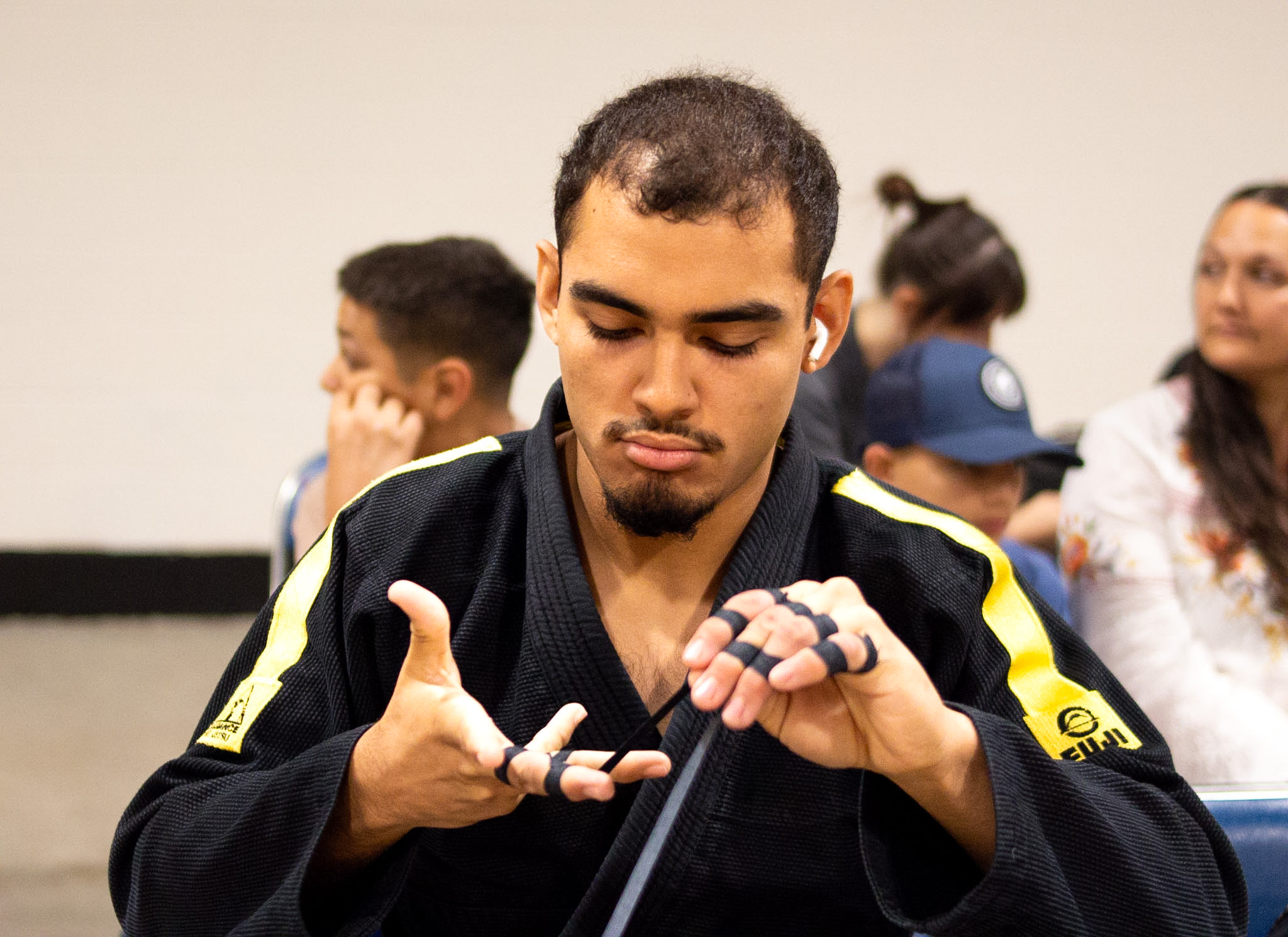 Alliance competitor taping fingers in warm-up before IBJJF Houston Open