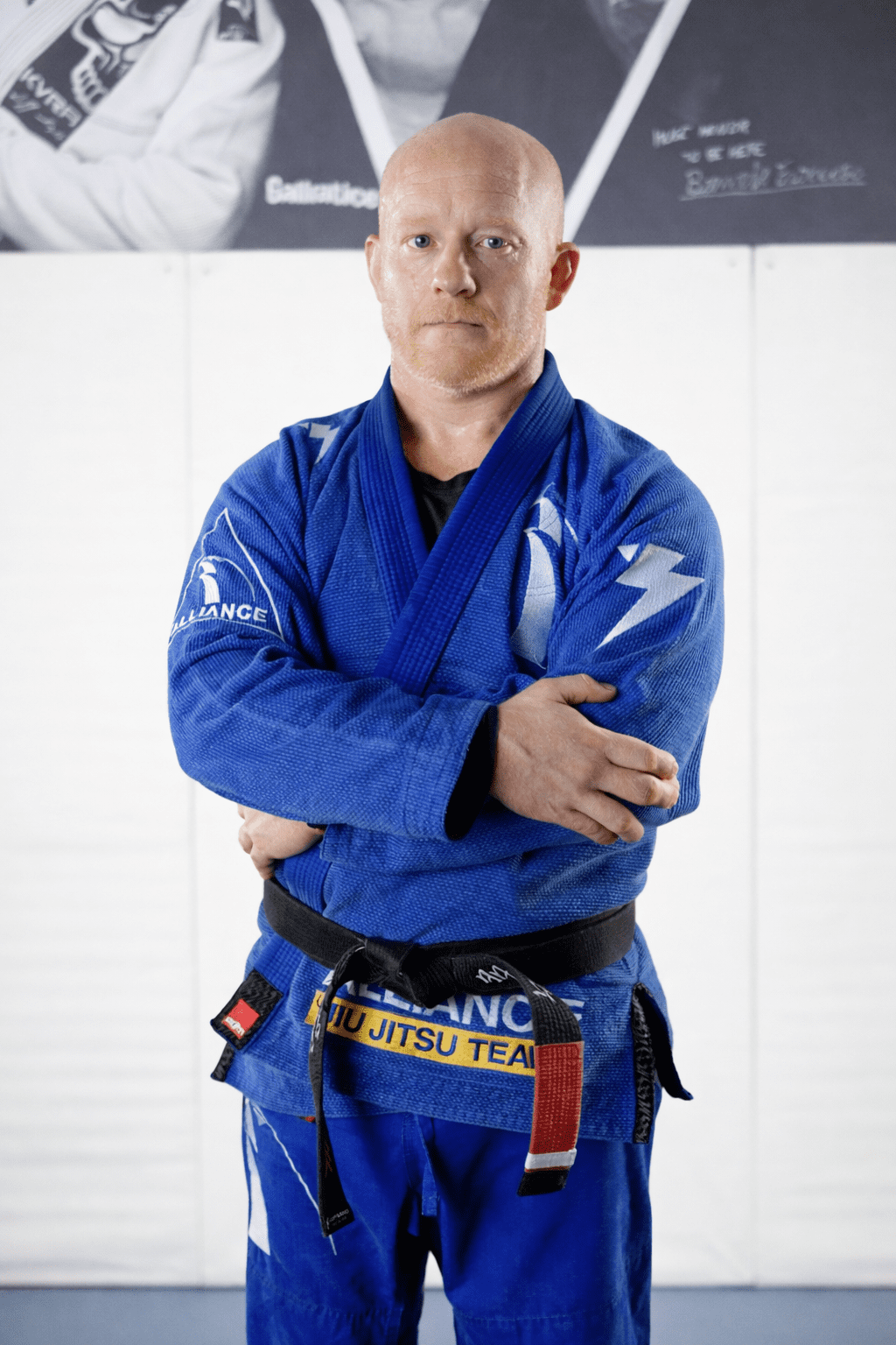 Coach Danny in a blue Alliance gi with a black belt at our Pearland academy