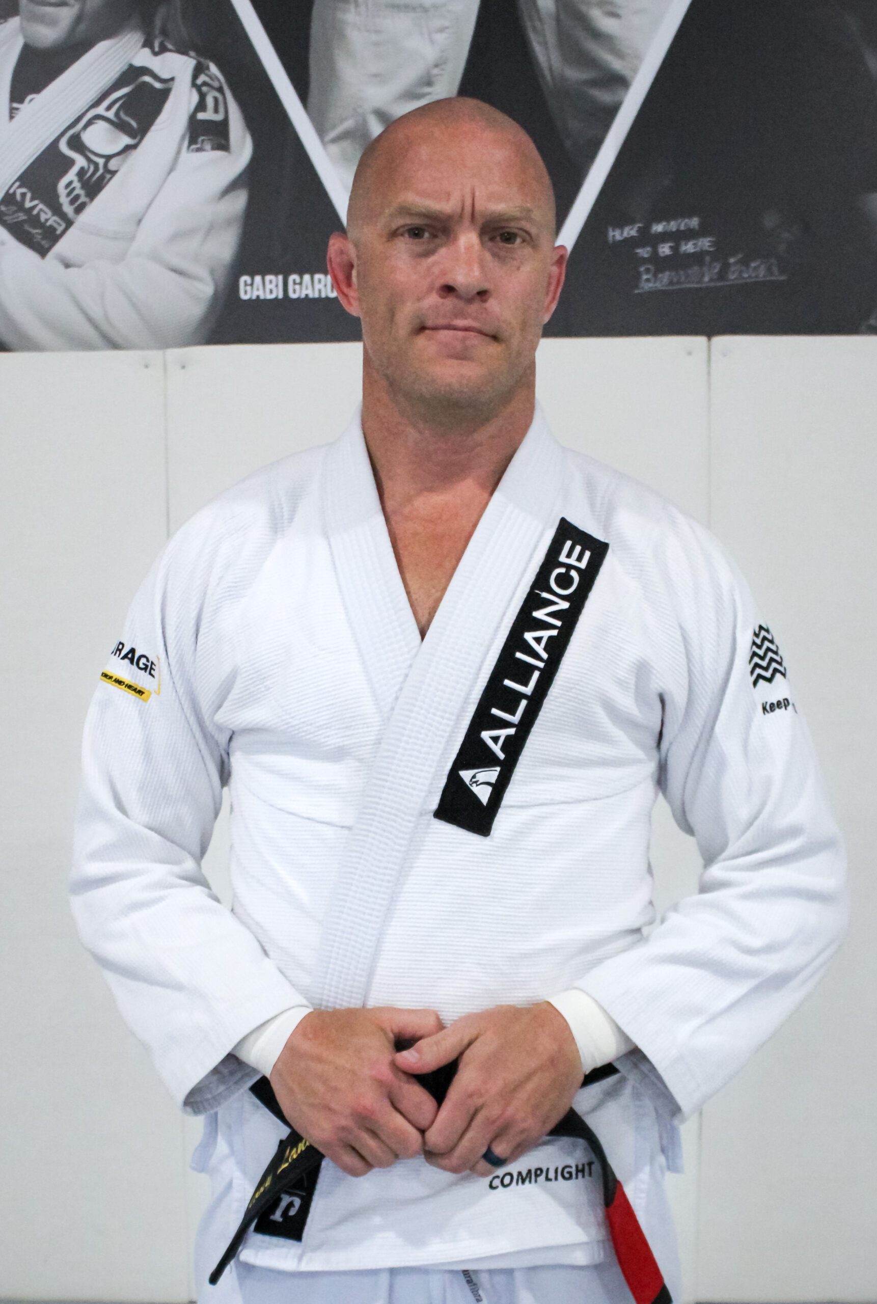 Coach Tony in a white Alliance gi with a black belt at our south Houston gym