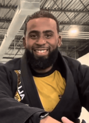 David Burkley smiling in his black Alliance gi after a transformation class