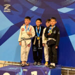 Four young Alliance grapplers on the kids podium at the IBJJF Houston Open tournament
