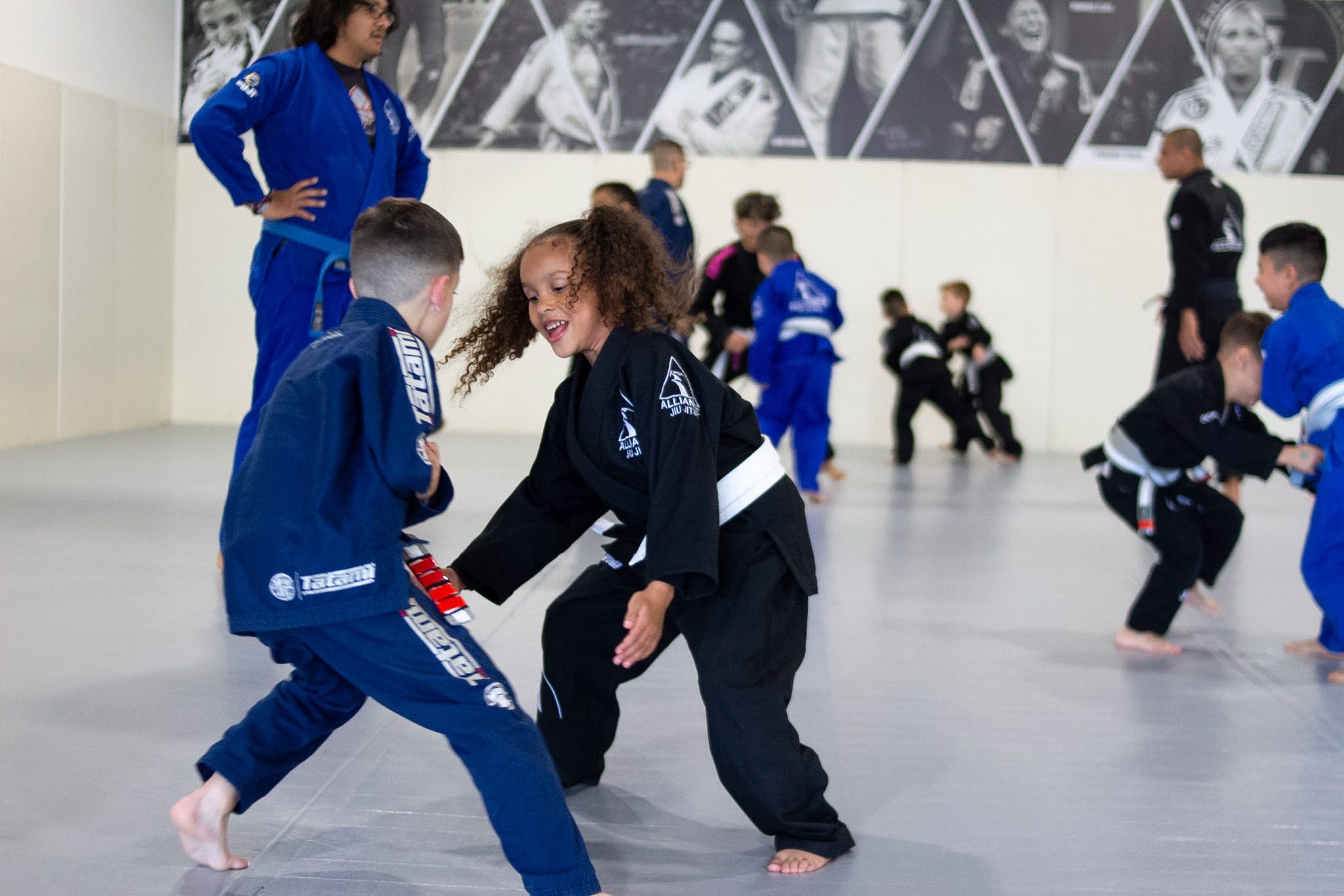 Smiling kids sparring during a youth jiu-jitsu class in Pearland
