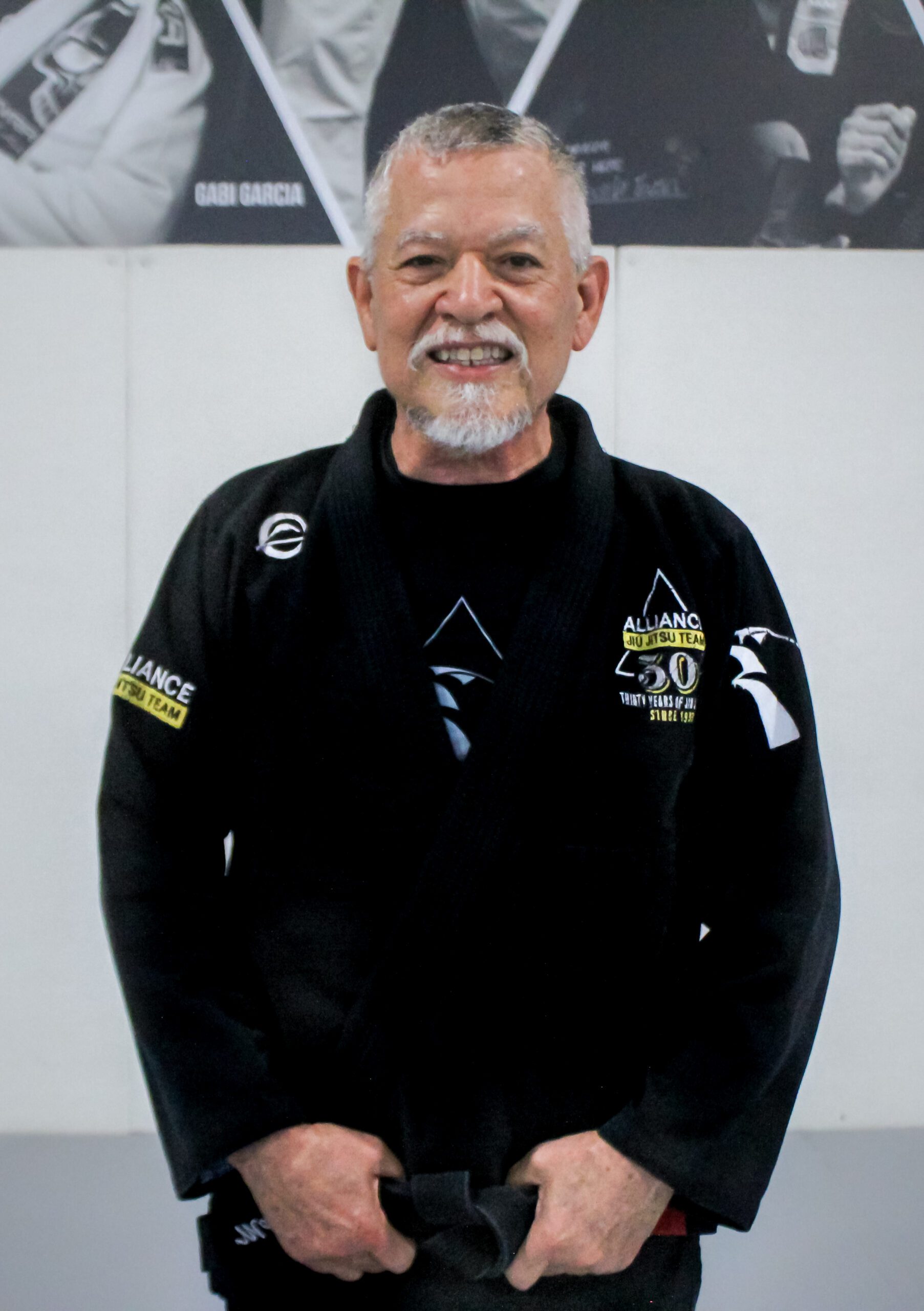 Martin Ochoa in his black Alliance gi with 30-year anniversary patches at the academy