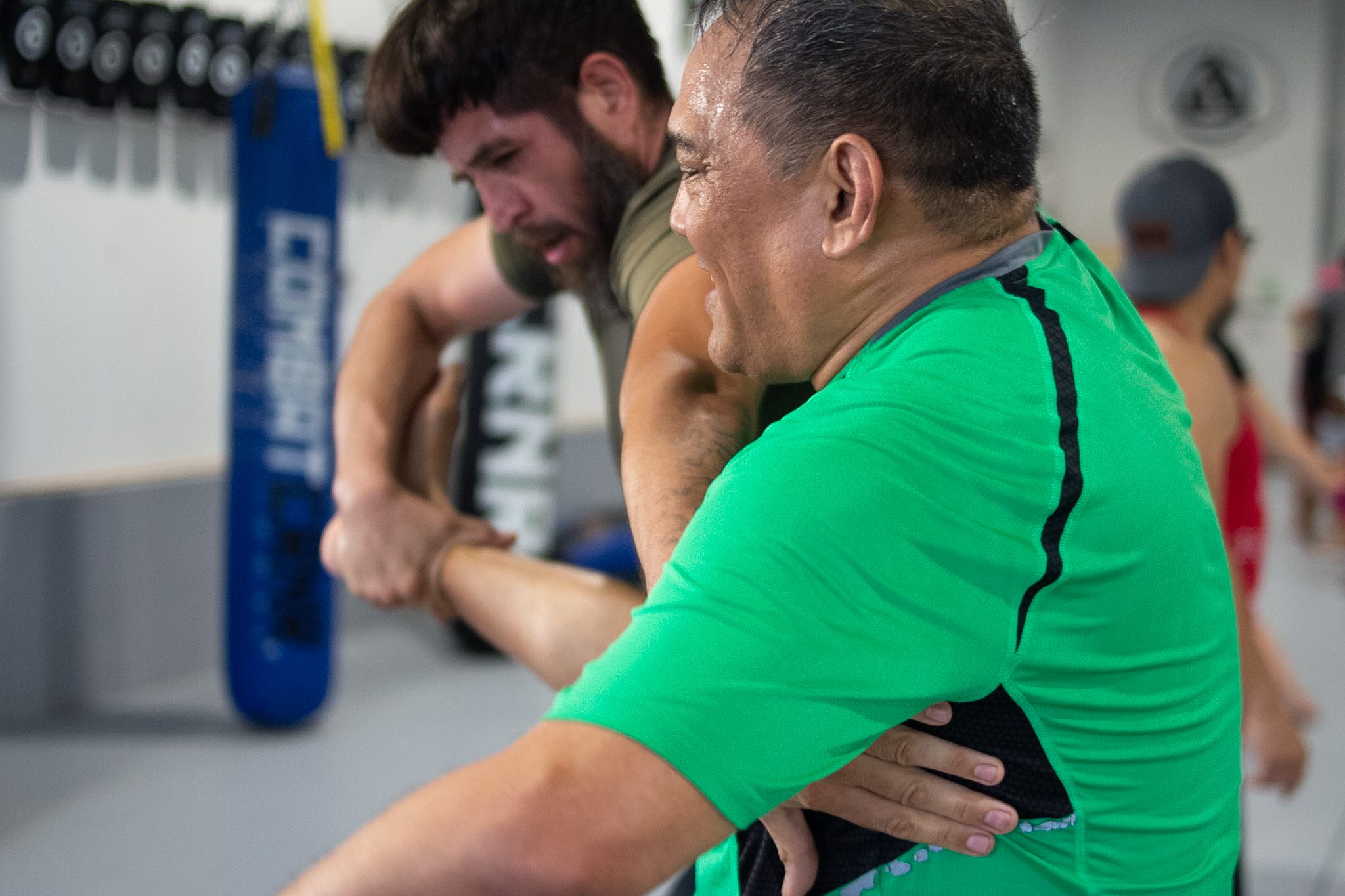 Close-up of two men working Muay Thai clinch and knee position during drilling