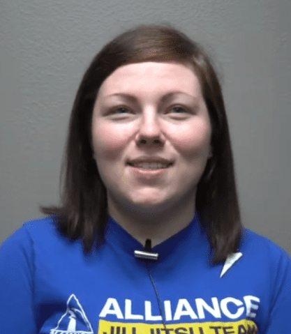 Olivia Vasquez in an Alliance Jiu Jitsu Team shirt during her video testimonial