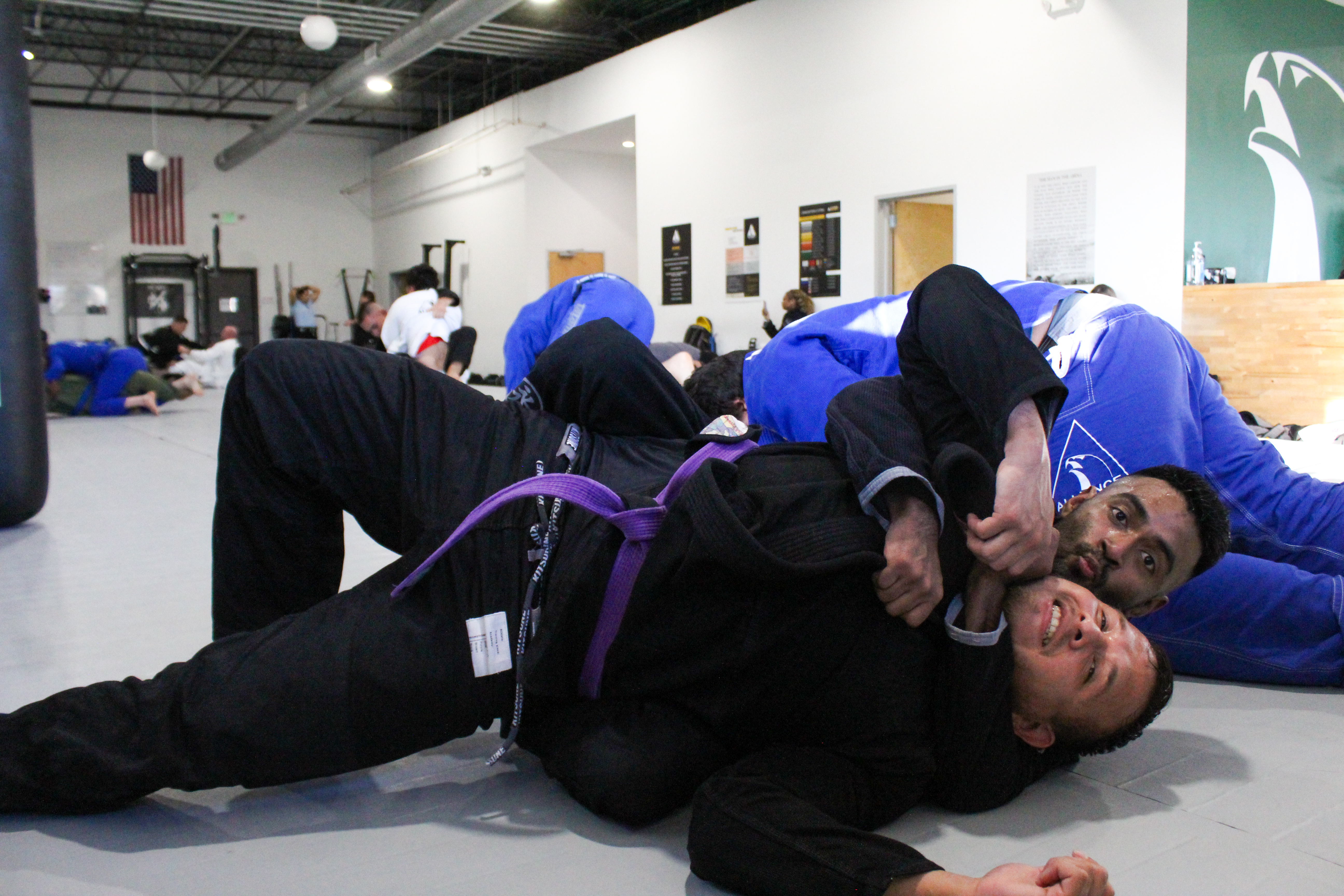 Purple belt securing back control during live rolling