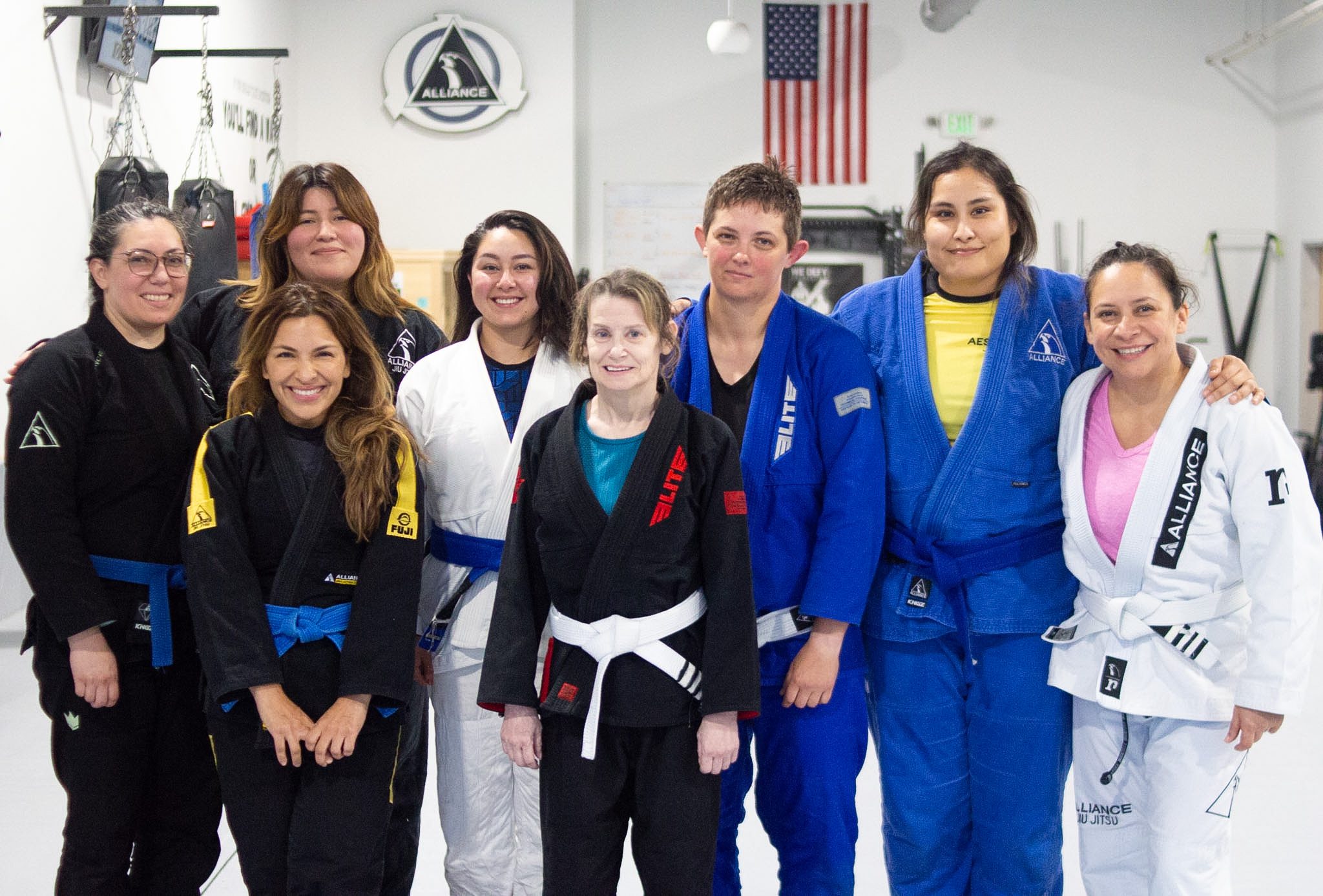 Group of eight women from Alliance BJJ Houston's women's class posing together