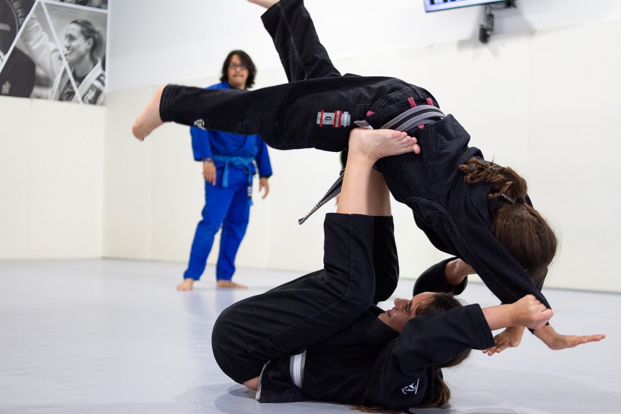 Two kids drilling a guard sweep during jiu-jitsu class