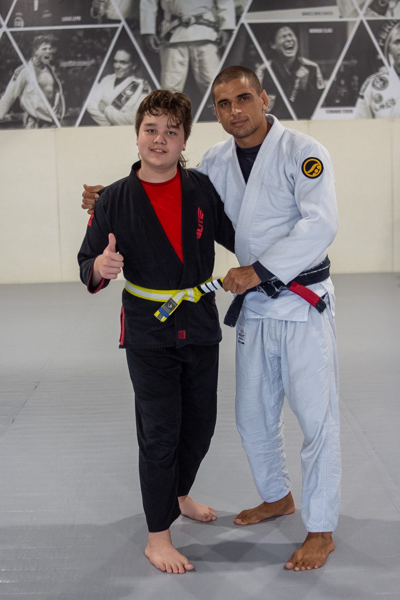 Older Junior Eagle promotes to yellow belt with head Alliance instructor