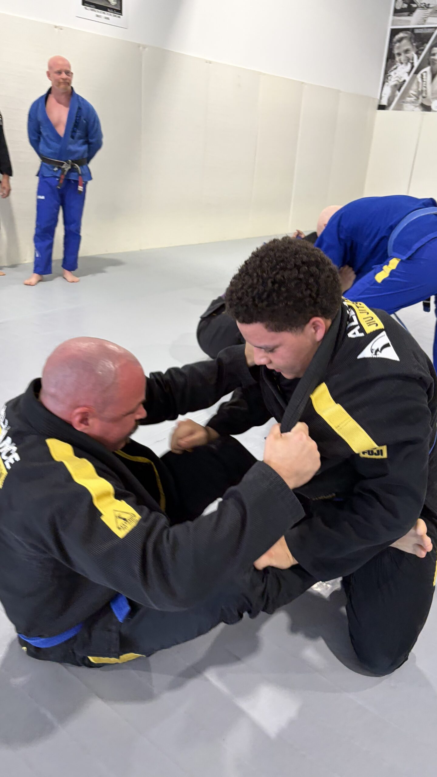Man shoots a takedown on a teammate wearing the Alliance eagle gi