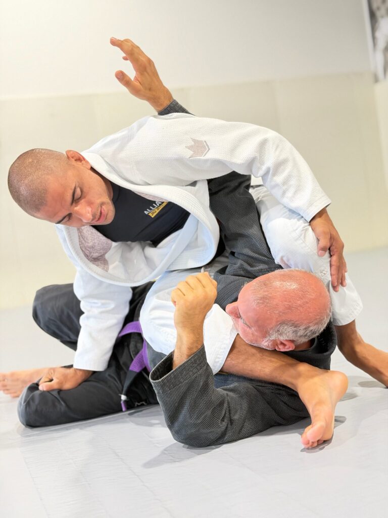 Head professor Alef works a guard pass on a training partner during class