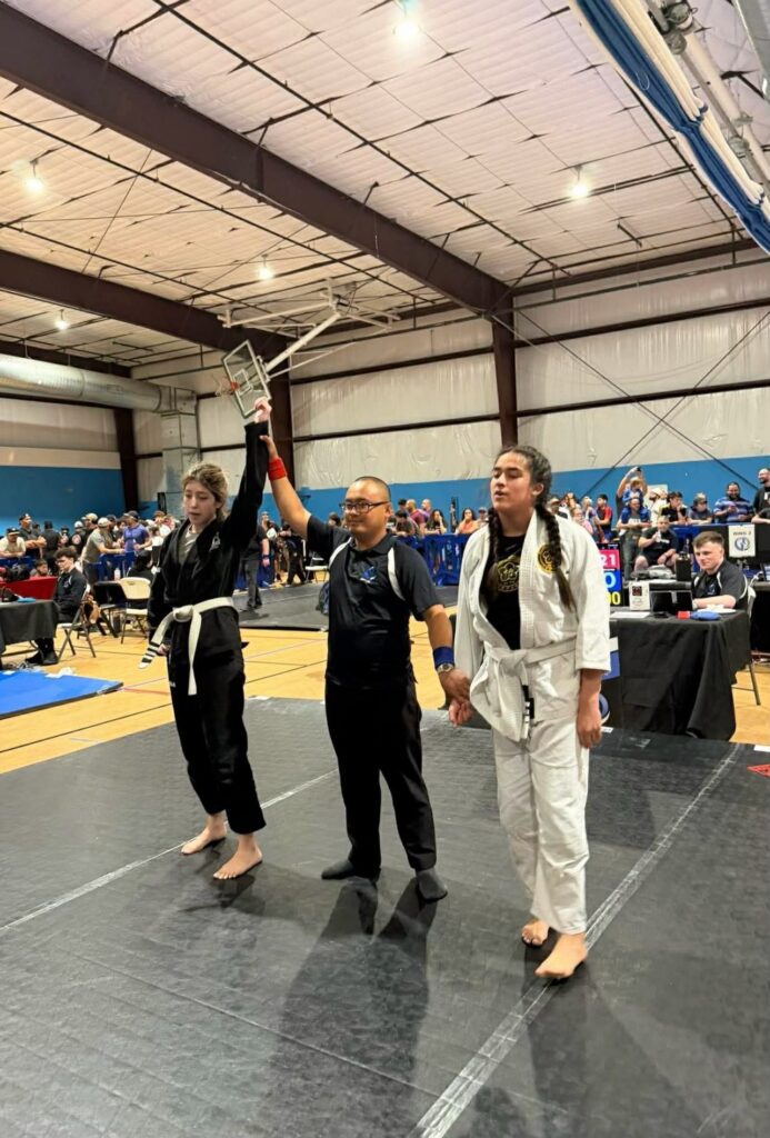 Referee raises the arm of the winning competitor at a Houston tournament