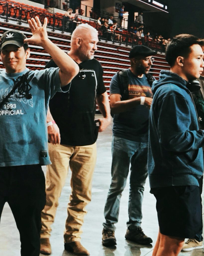 Alliance BJJ Houston coaches watch matches from the arena floor between rounds