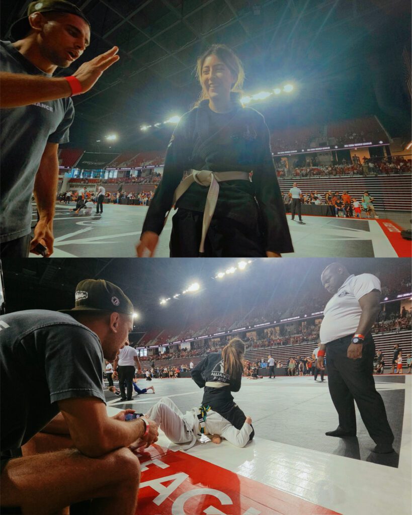 Larissa Rosas steps off the mat as her coach reaches out for a high five