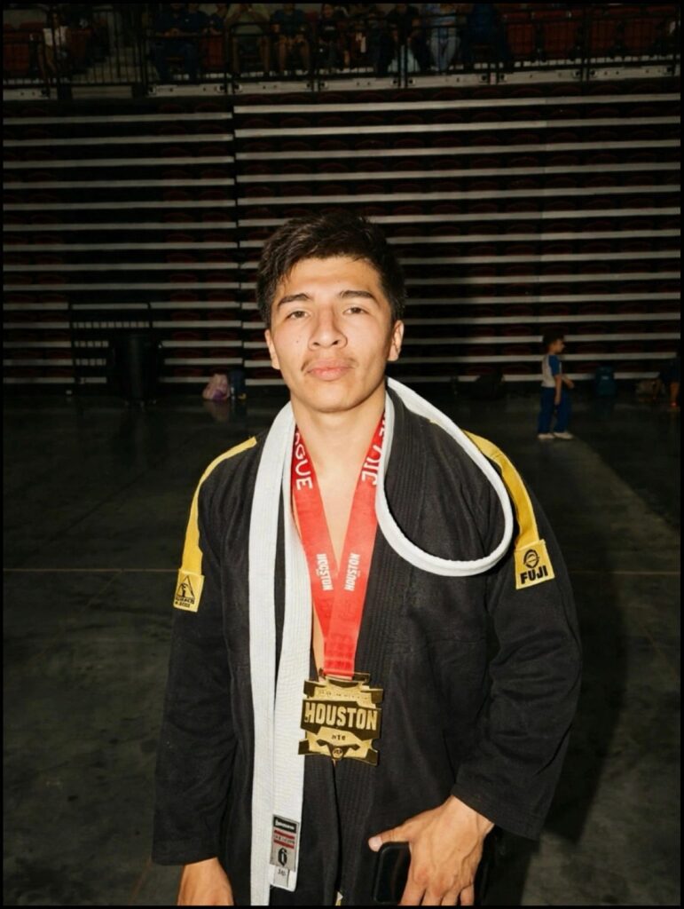 Max Estrada wears his gold medal and white belt after the Adults division