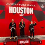 Max Estrada stands on the top step of the podium with his gold medal