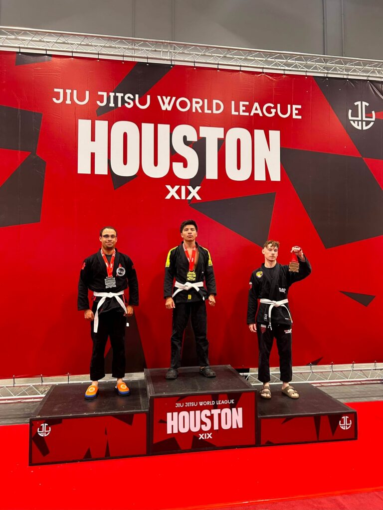 Max Estrada stands on the top step of the podium with his gold medal