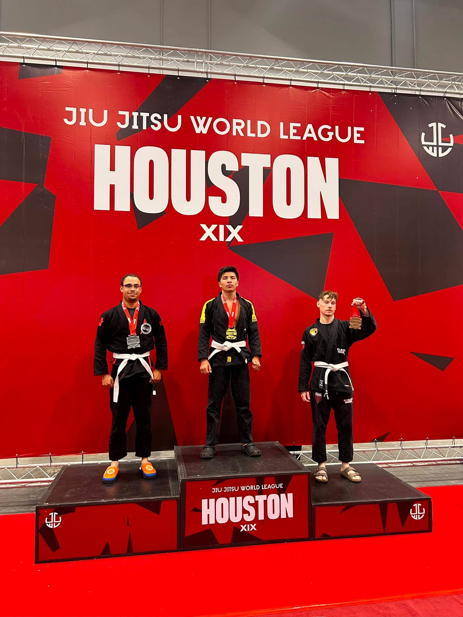 Max Estrada stands on the top step of the podium with his gold medal