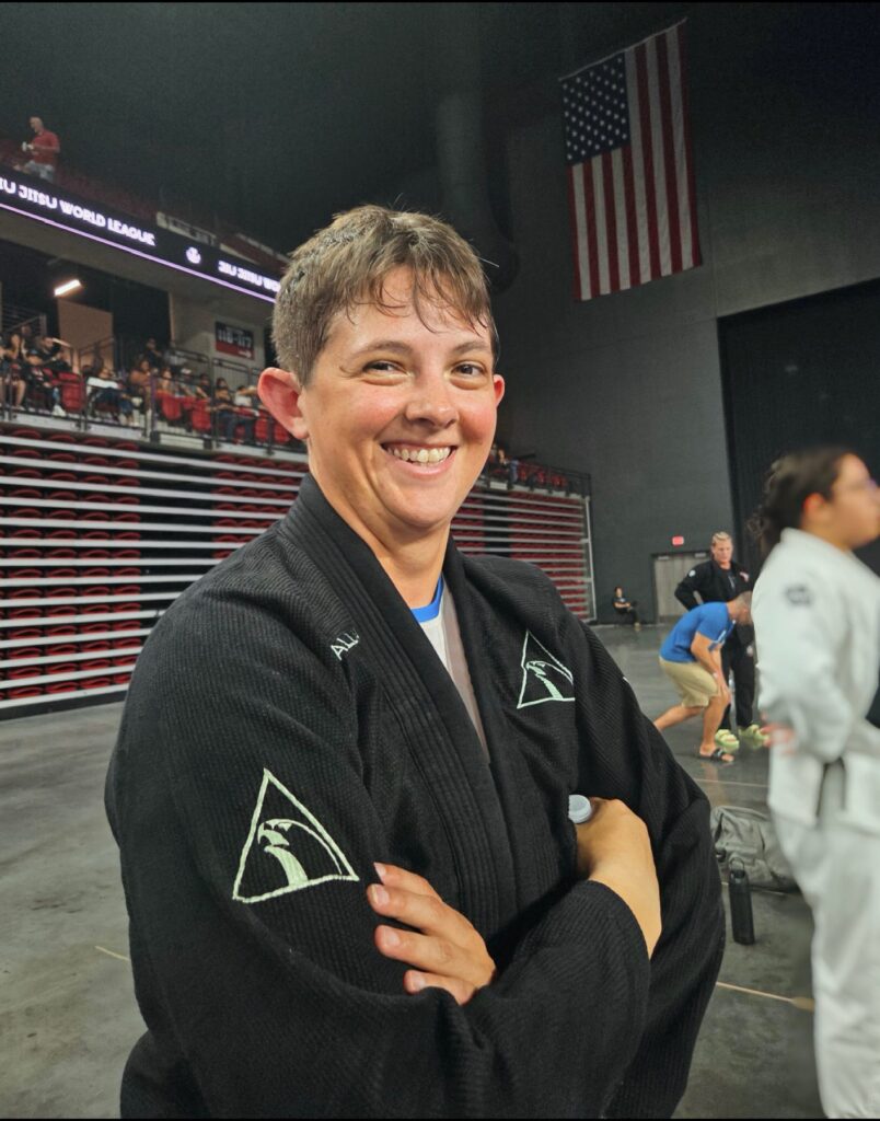 Nicole Sennholtz smiles in her Alliance gi between matches at the tournament