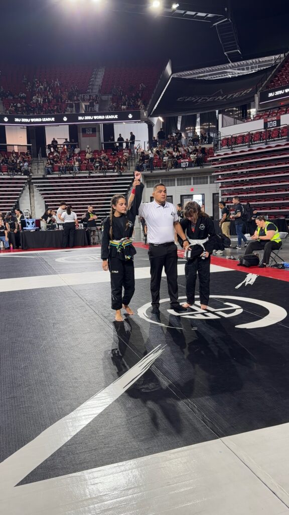 Referee raises Realyn Oehlert hand at the end of a Jr Teen division match